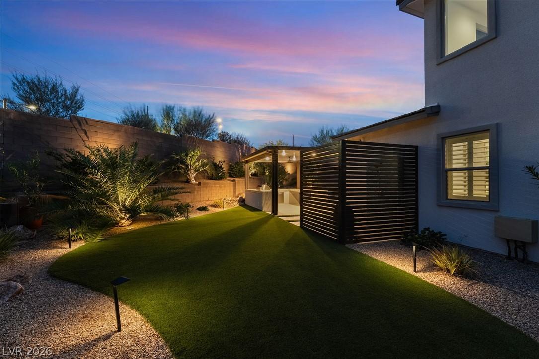 Private landscaped backyard oasis with mature palms in Summerlin West