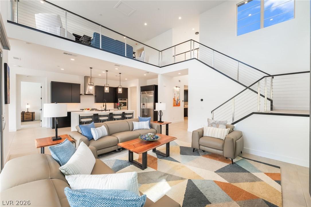 Two-story great room featuring a designer fireplace at 127 Malpaso in Summerlin West