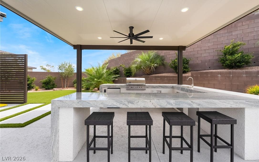 Outdoor kitchen island bar seating perfect for poolside entertaining
