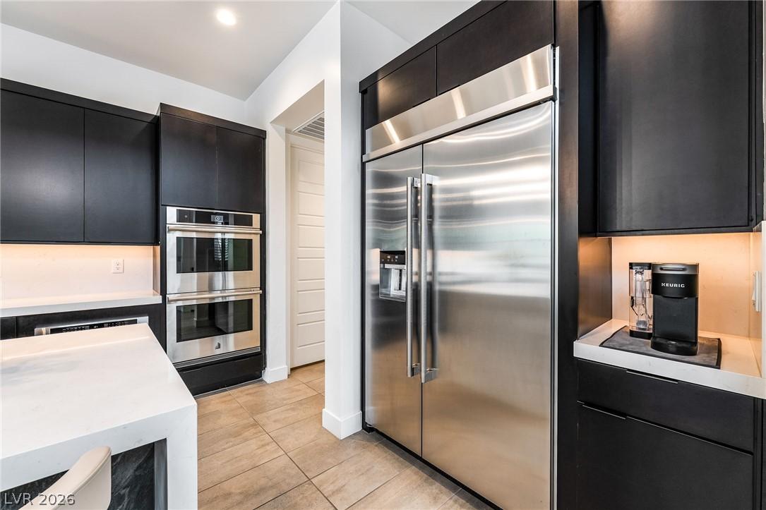 High-end kitchen with double ovens and custom gas cooktop in Summerlin luxury home