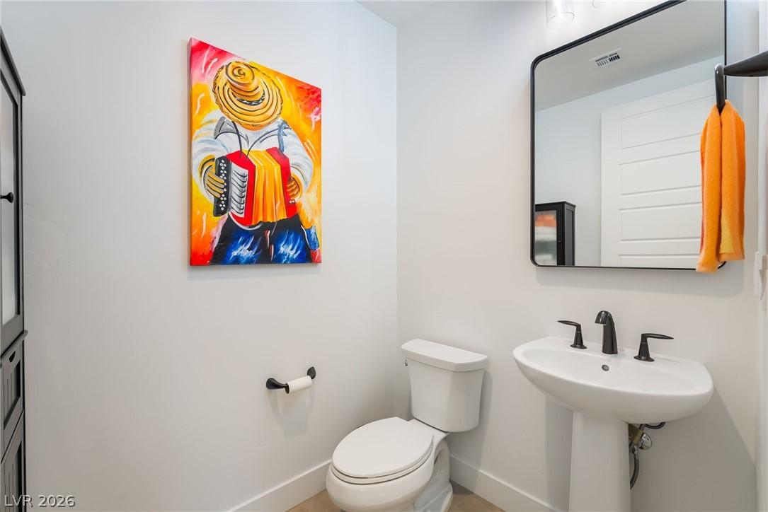 Designer powder room featuring luxury fixtures at 127 Malpaso St