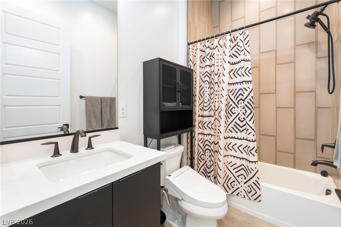 Modern secondary bathroom with quartz countertops and designer tile work