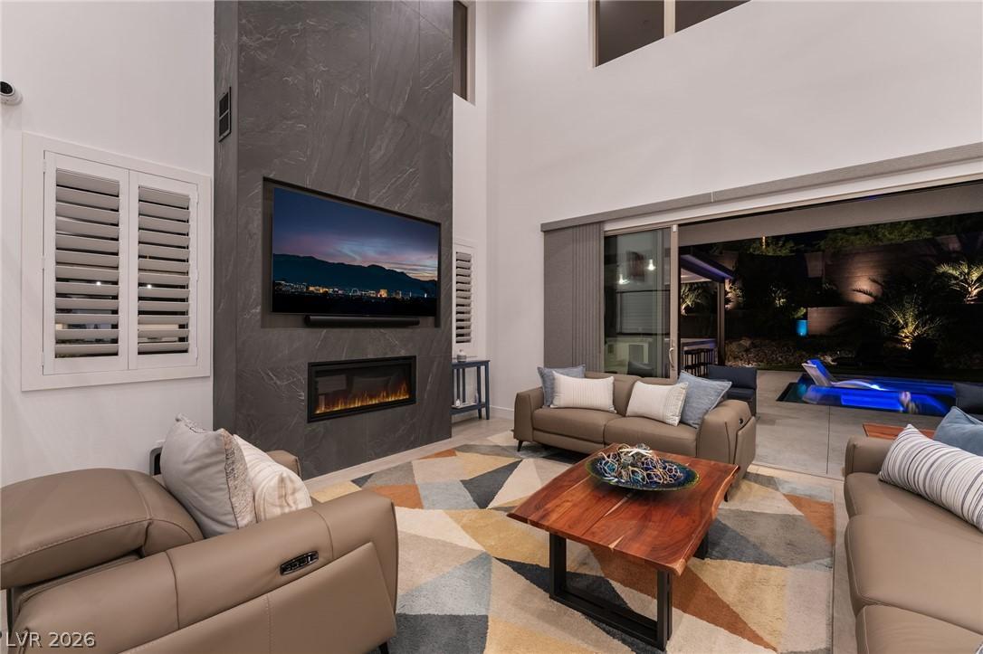 Bright living area featuring custom plantation shutters and modern design