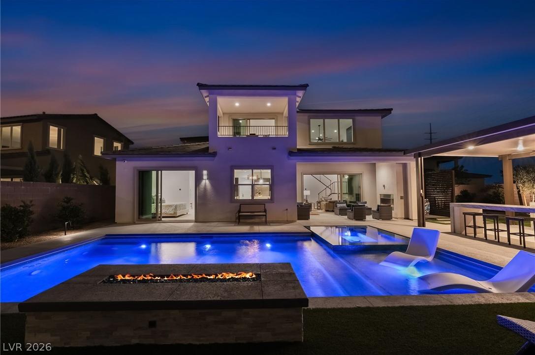 Resort-style backyard with private swimming pool, spa, and fire feature in Summerlin