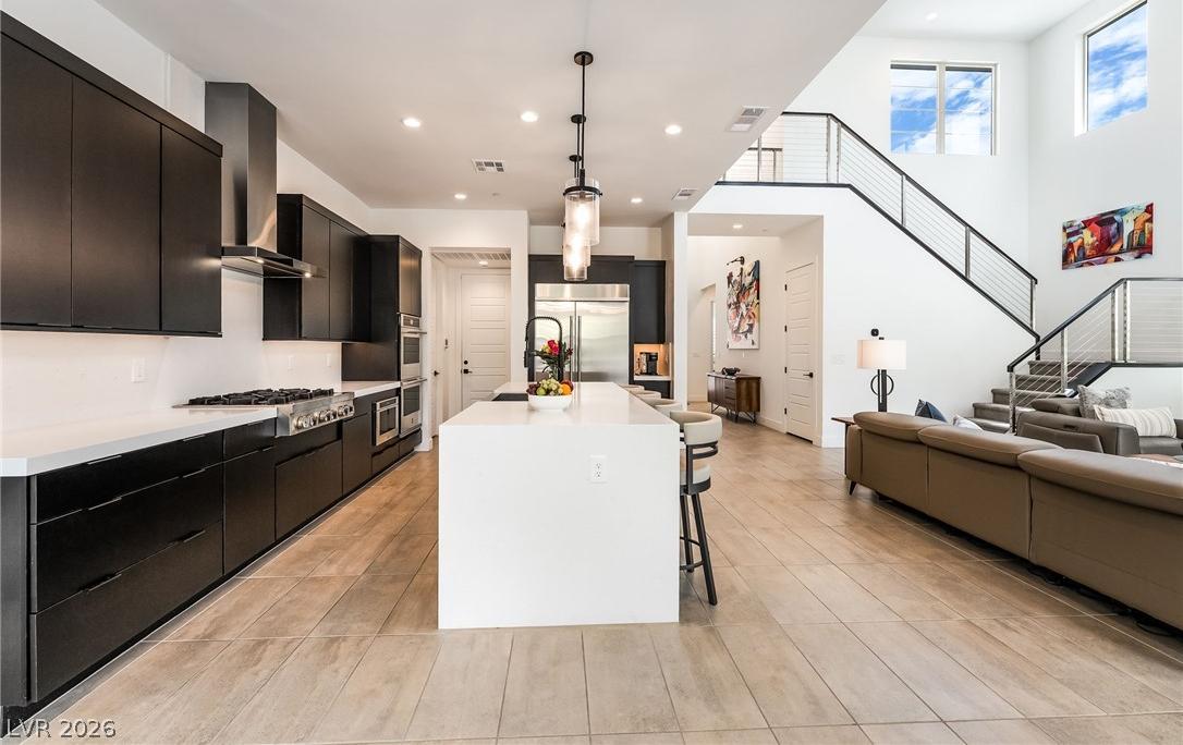 Waterfall quartz kitchen island with counter bar seating for entertaining