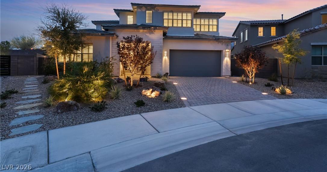 Evening exterior elevation highlighting custom architectural lighting at 127 Malpaso