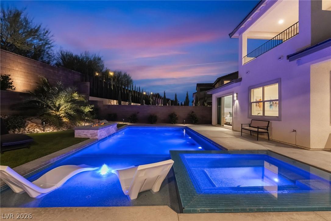 Sparkling pool and integrated spa illuminated at dusk at 127 Malpaso