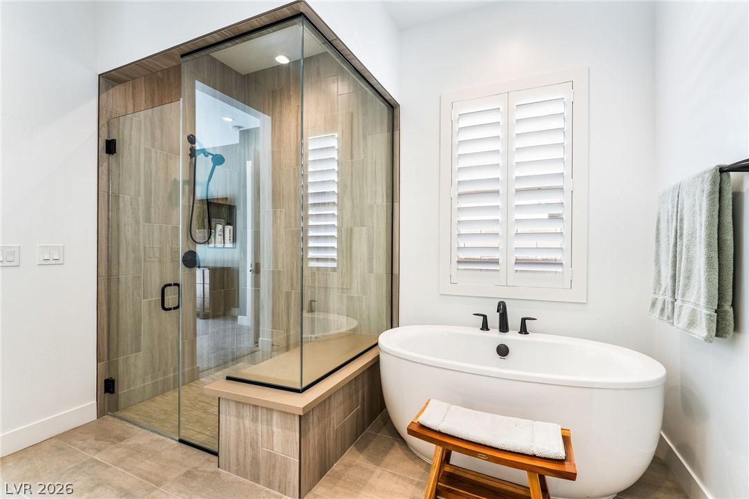 Spa-inspired primary bathroom with a modern freestanding soaking tub at 127 Malpaso
