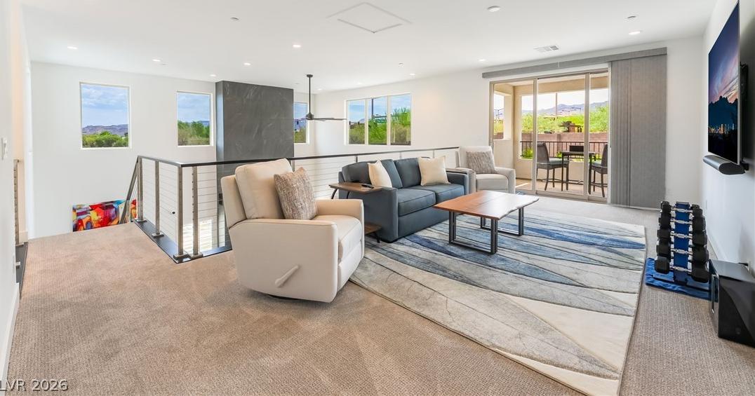 Expansive second-floor loft opening to an upper covered deck with Las Vegas views