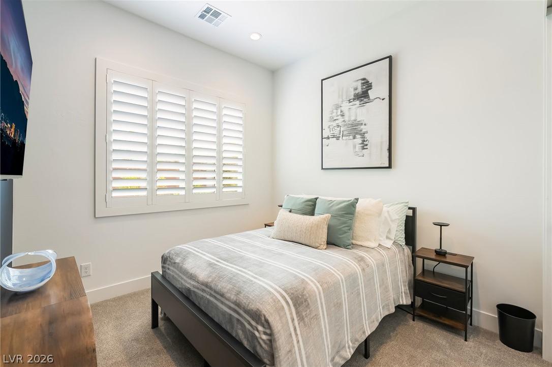Light-filled second-floor bedroom featuring a custom walk-in closet